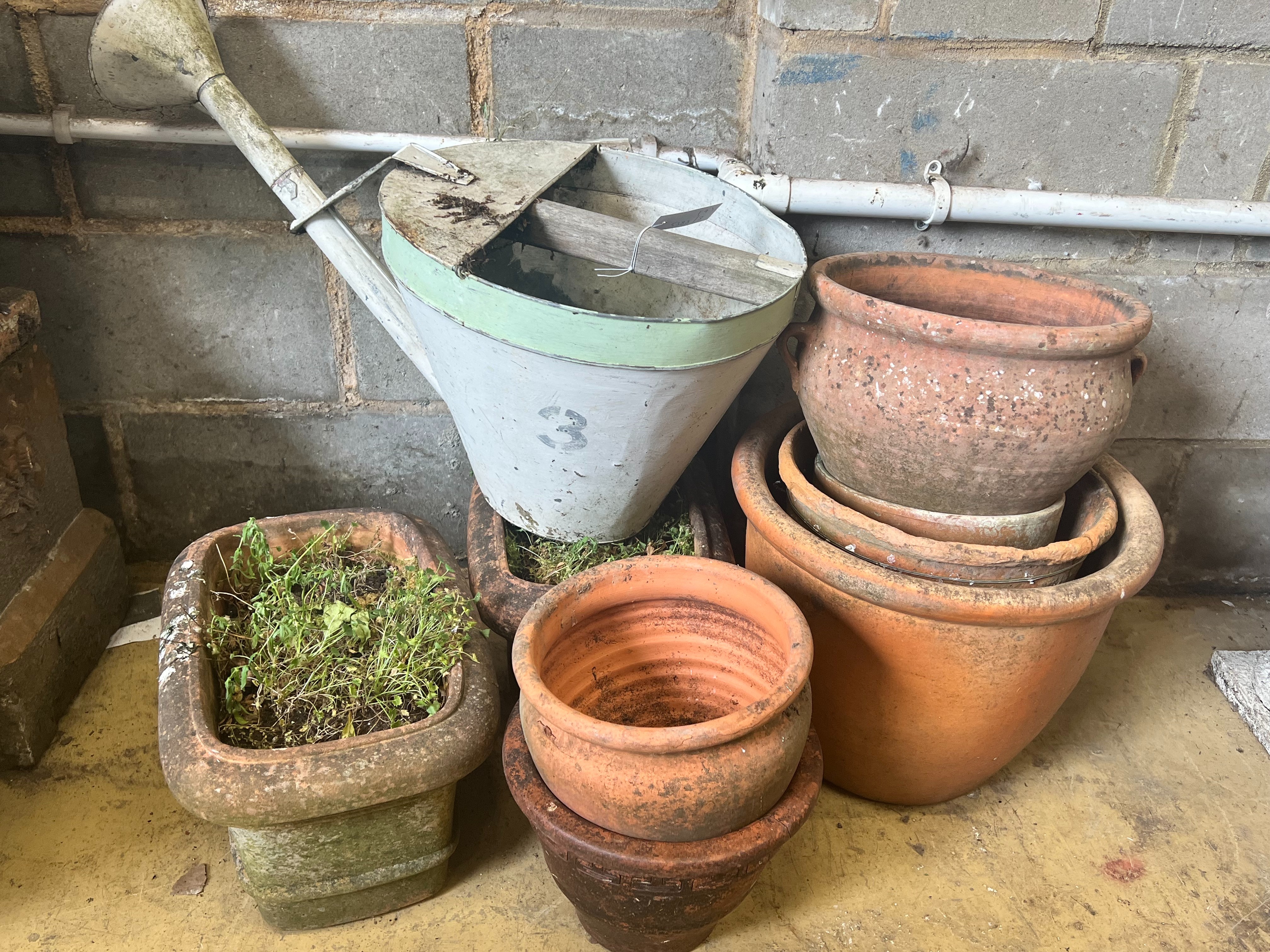 A pair of rectangular terracotta garden planters, width 40cm, a vintage watering can and six circular terracotta planters